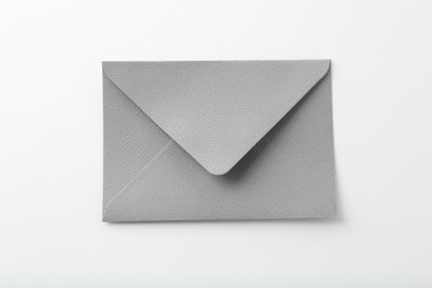 Photo of One closed grey envelope isolated on white, top view