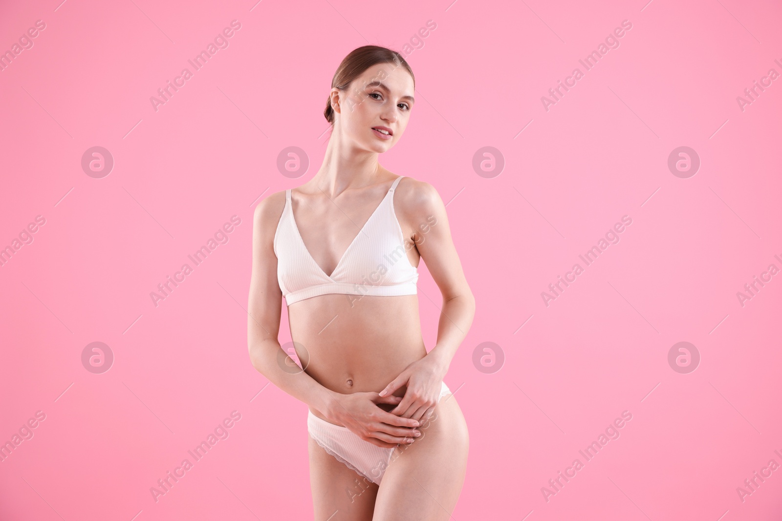 Woman wearing beautiful underwear on pink background Photo of Woman wearing beautiful underwear on pink background