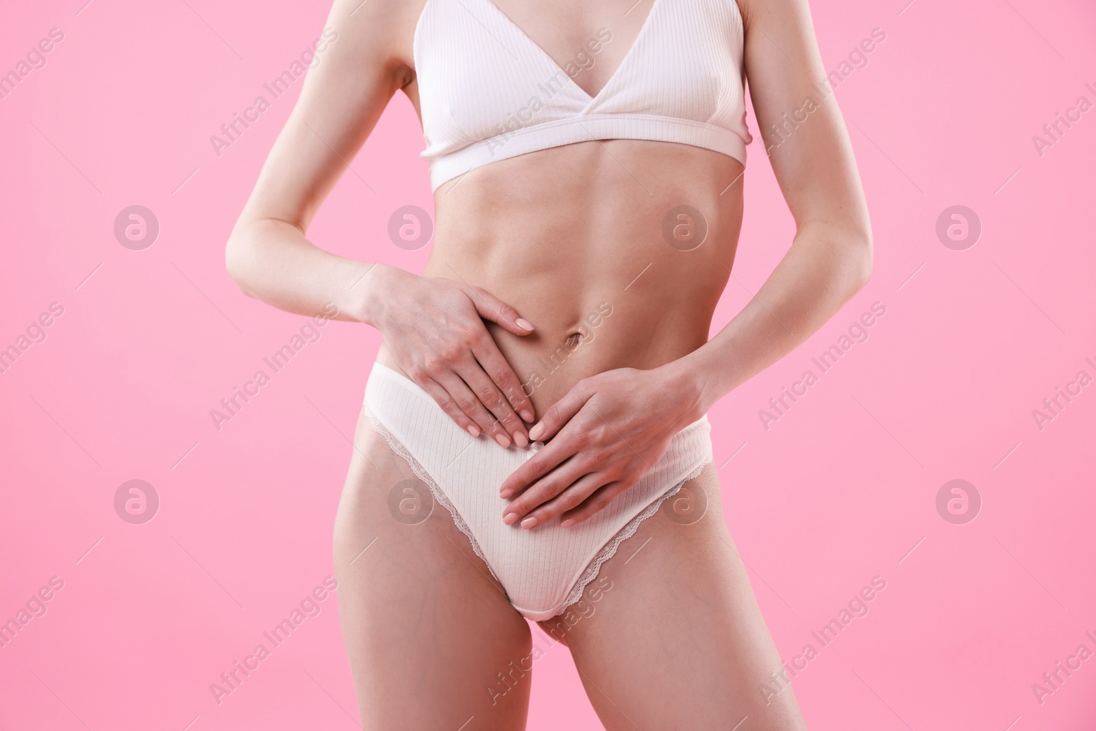 Woman wearing beautiful underwear on pink background, closeup Photo of Woman wearing beautiful underwear on pink background, closeup