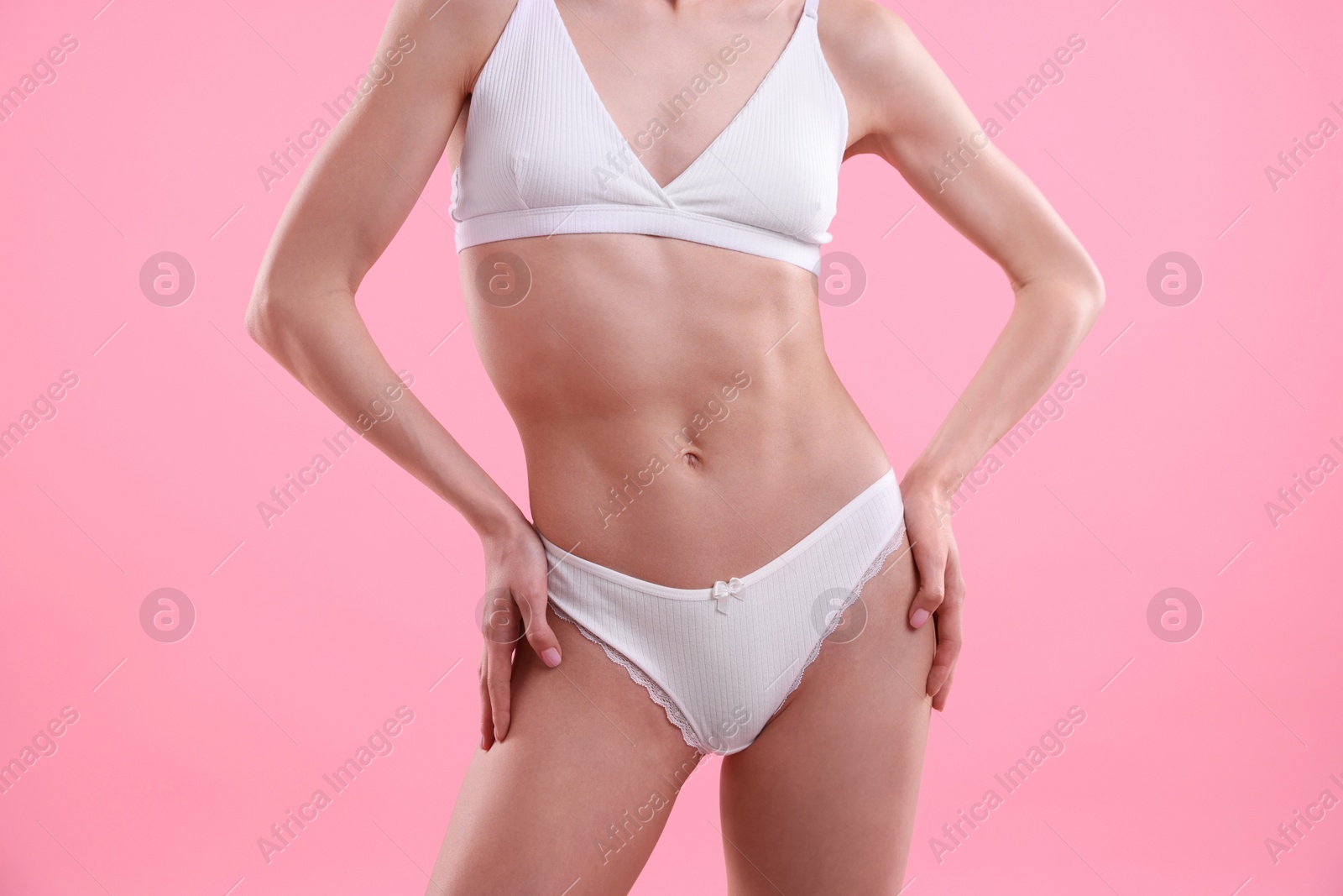 Woman wearing beautiful underwear on pink background, closeup Photo of Woman wearing beautiful underwear on pink background, closeup