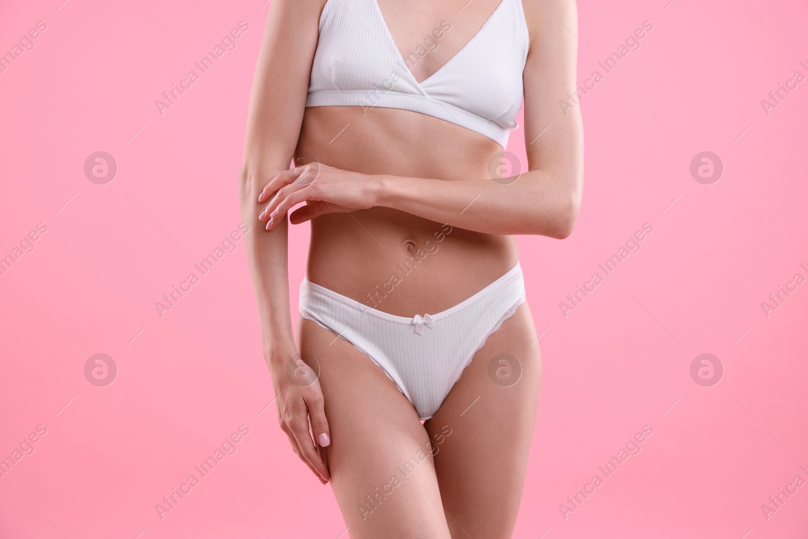 Woman wearing beautiful underwear on pink background, closeup Photo of Woman wearing beautiful underwear on pink background, closeup