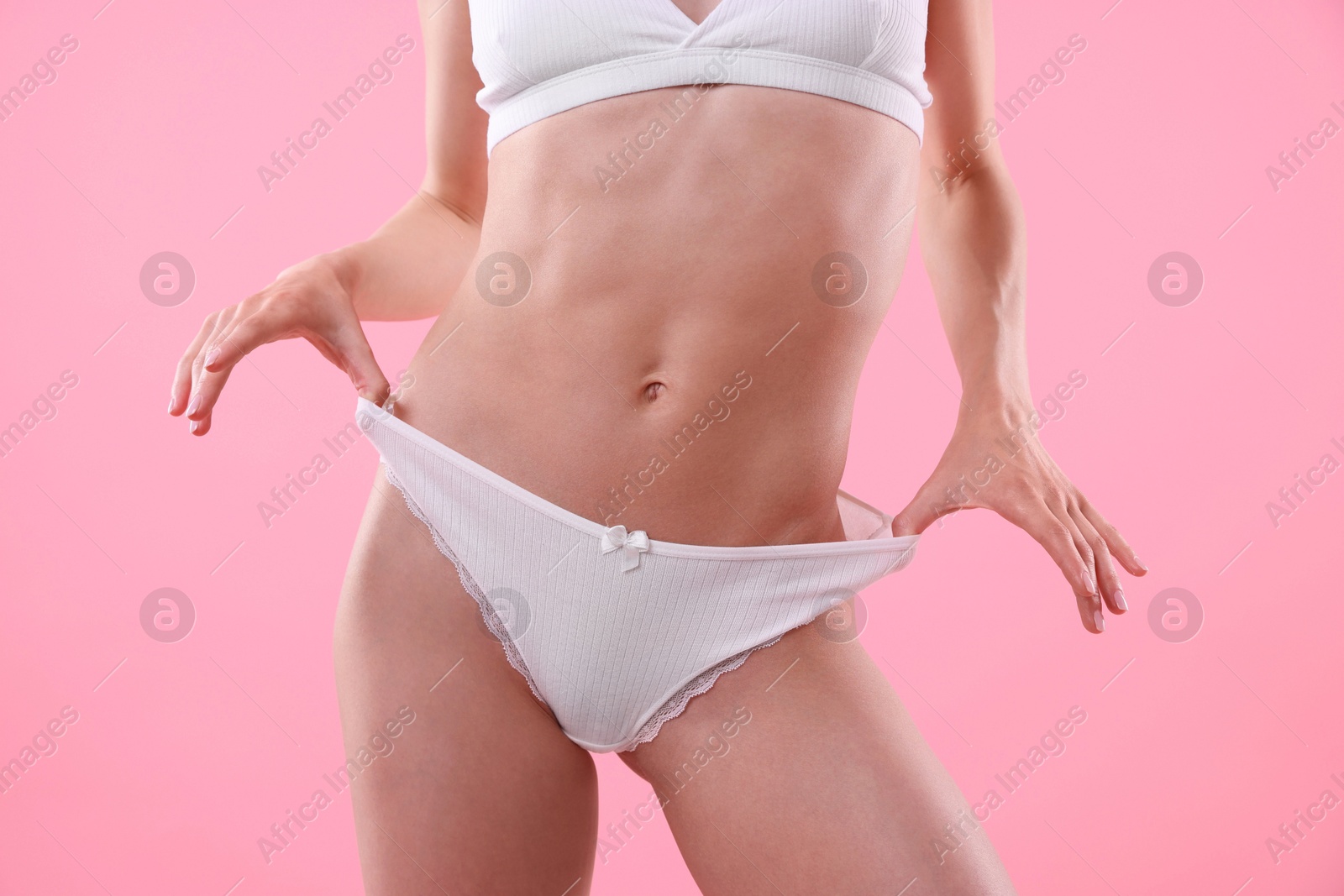 Woman wearing beautiful underwear on pink background, closeup Photo of Woman wearing beautiful underwear on pink background, closeup