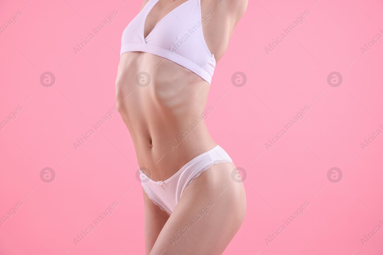 Woman wearing beautiful underwear on pink background, closeup Photo of Woman wearing beautiful underwear on pink background, closeup