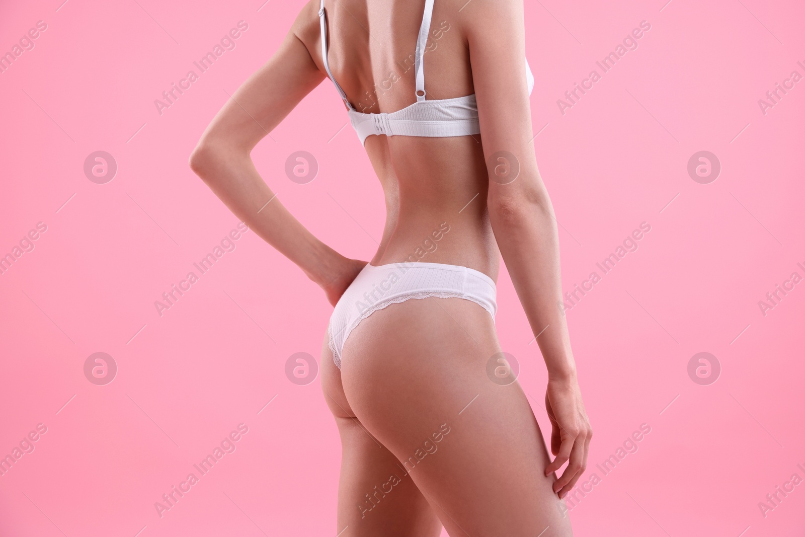 Woman wearing beautiful underwear on pink background, closeup Photo of Woman wearing beautiful underwear on pink background, closeup