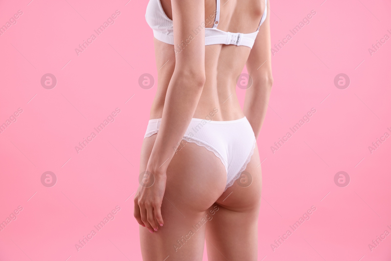 Woman wearing beautiful underwear on pink background, closeup Photo of Woman wearing beautiful underwear on pink background, closeup
