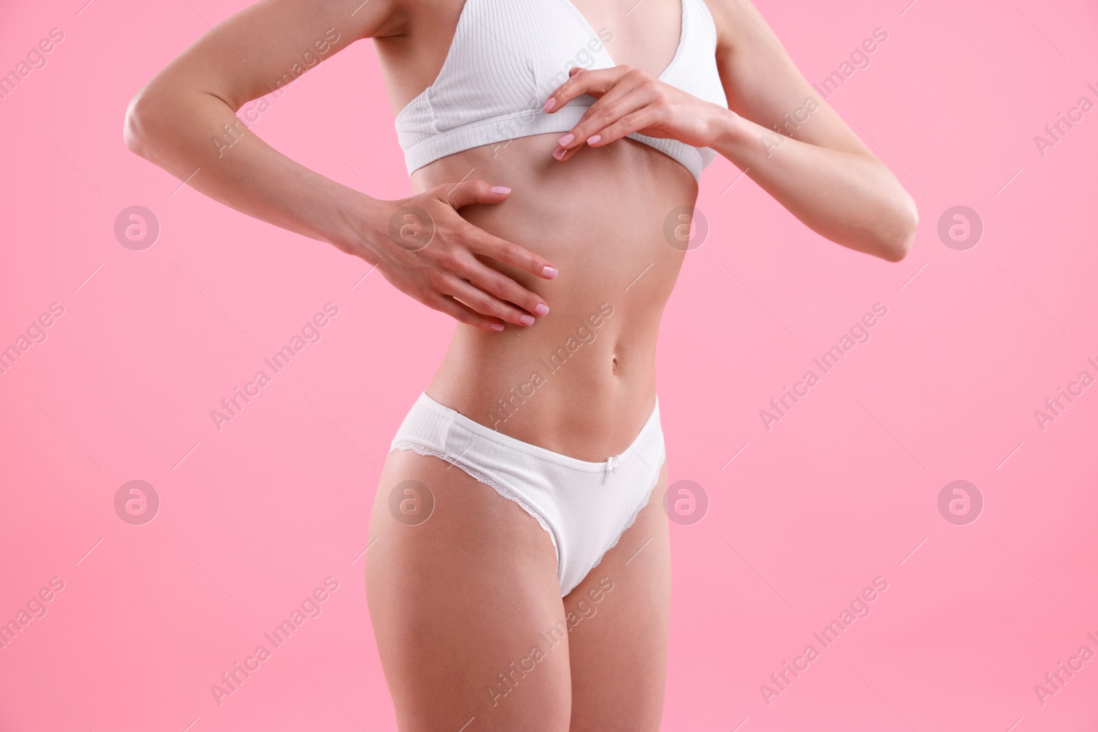 Woman wearing beautiful underwear on pink background, closeup Photo of Woman wearing beautiful underwear on pink background, closeup