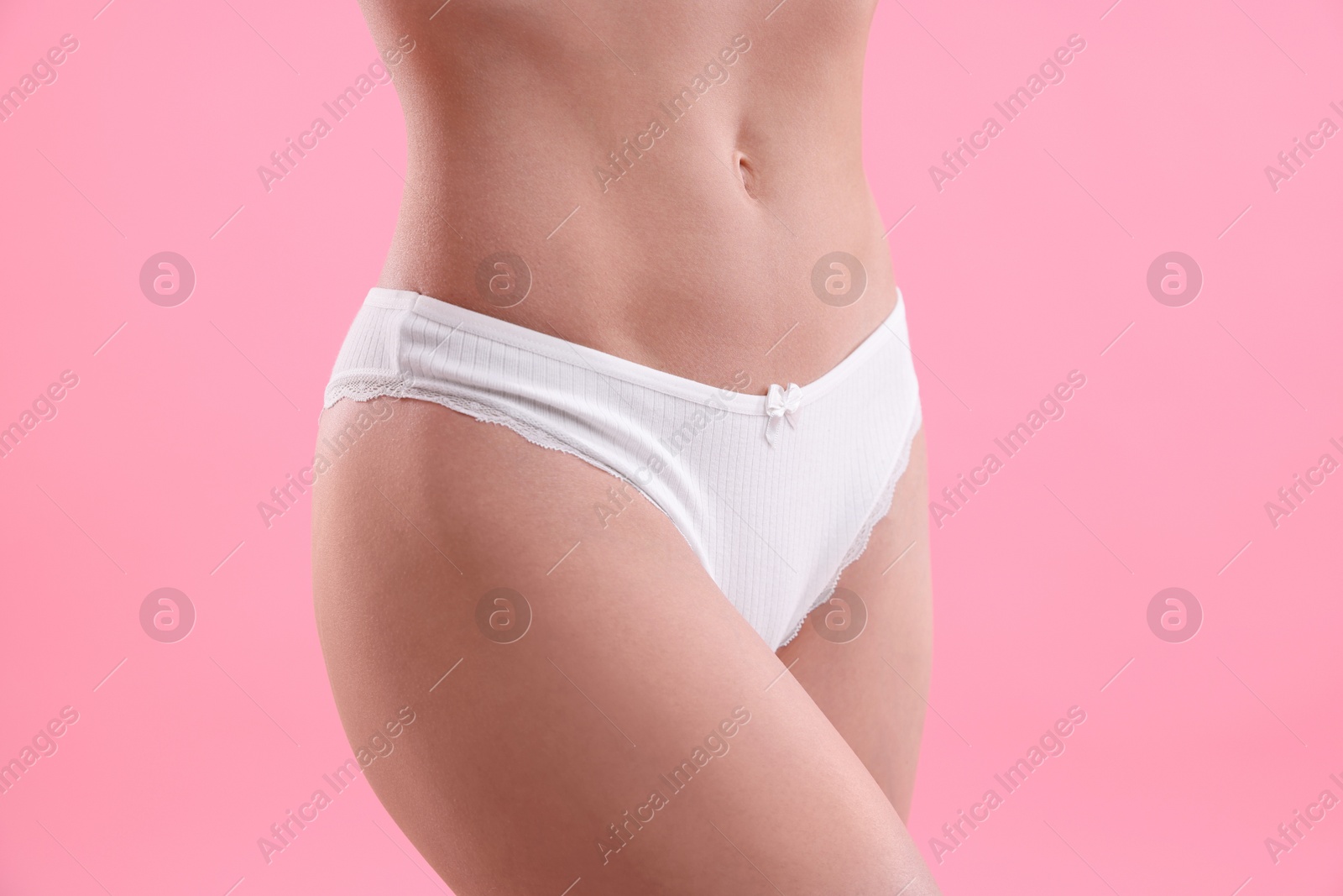 Woman wearing beautiful underwear on pink background, closeup Photo of Woman wearing beautiful underwear on pink background, closeup