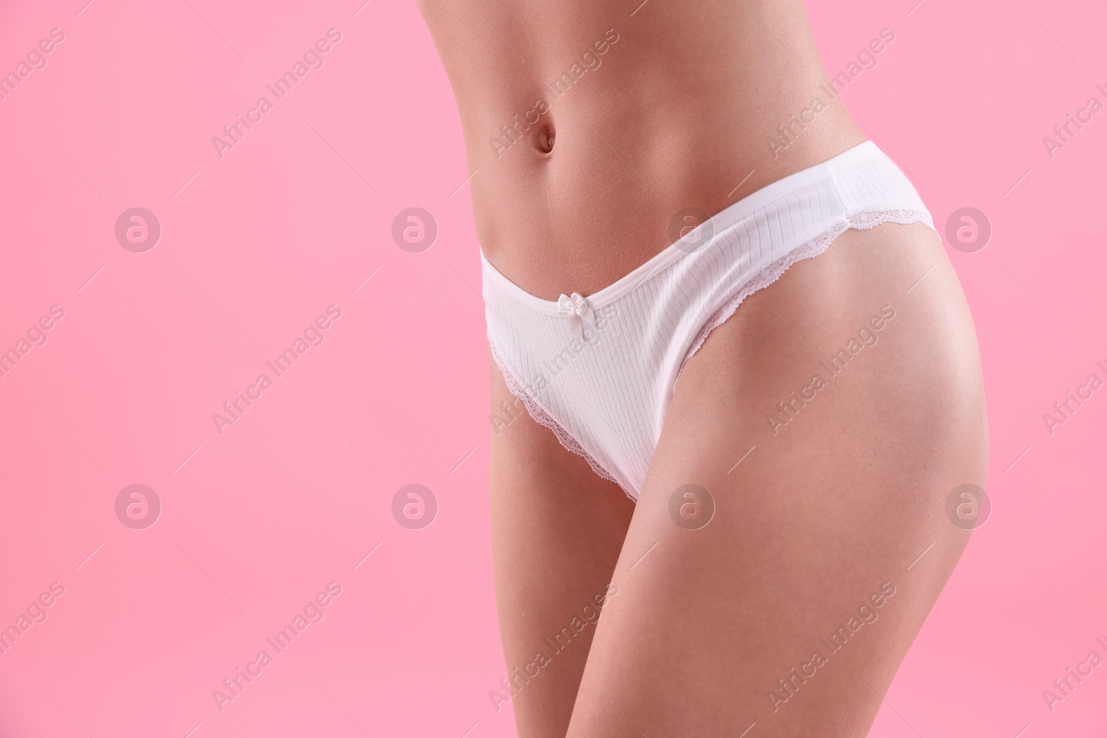 Woman wearing beautiful underwear on pink background, closeup. Space for text Photo of Woman wearing beautiful underwear on pink background, closeup. Space for text