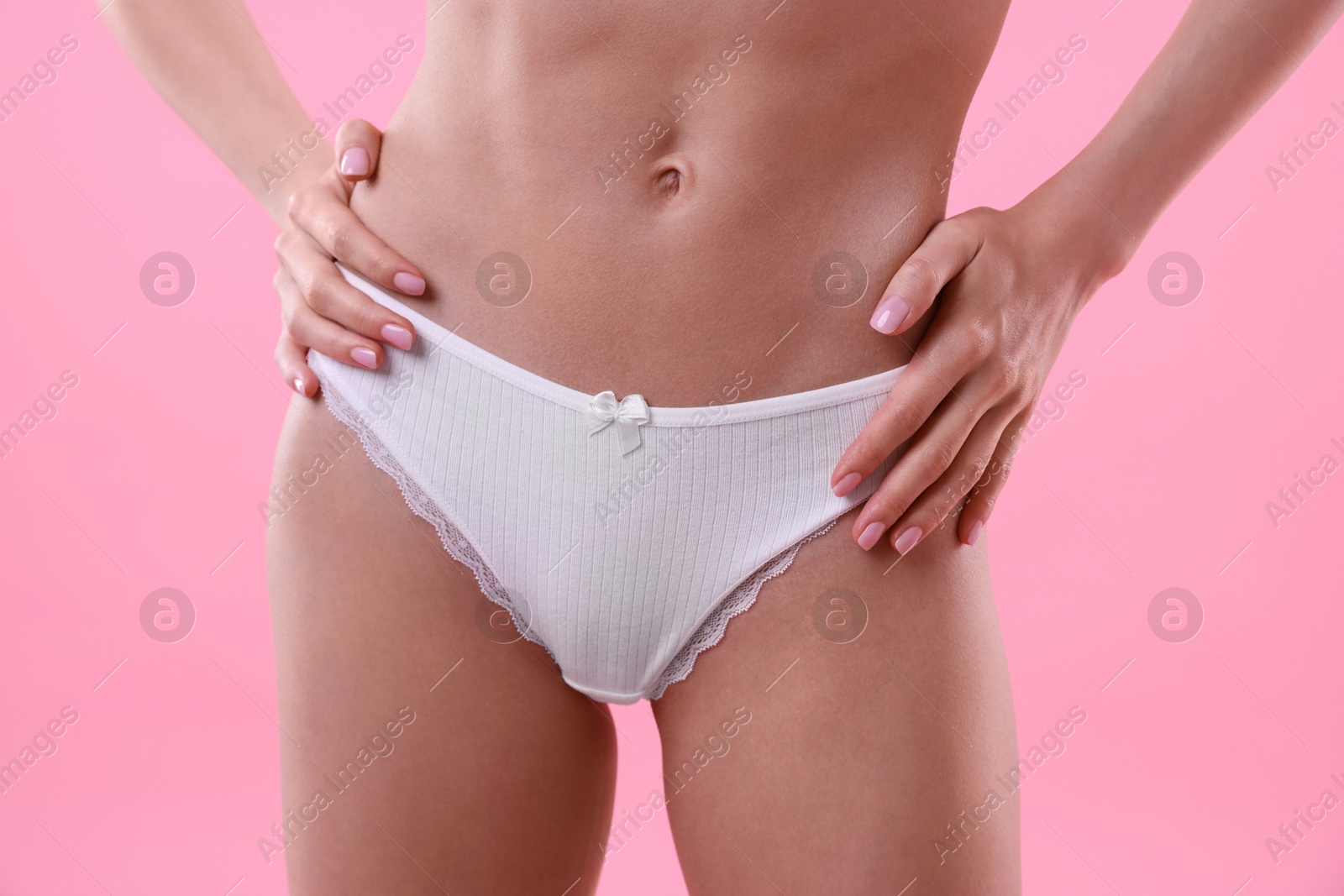 Woman wearing beautiful underwear on pink background, closeup Photo of Woman wearing beautiful underwear on pink background, closeup