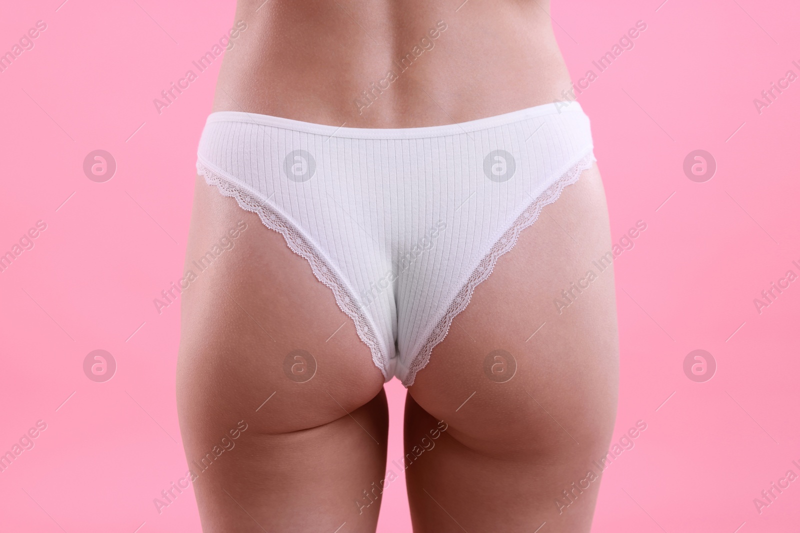 Woman wearing beautiful underwear on pink background, closeup Photo of Woman wearing beautiful underwear on pink background, closeup