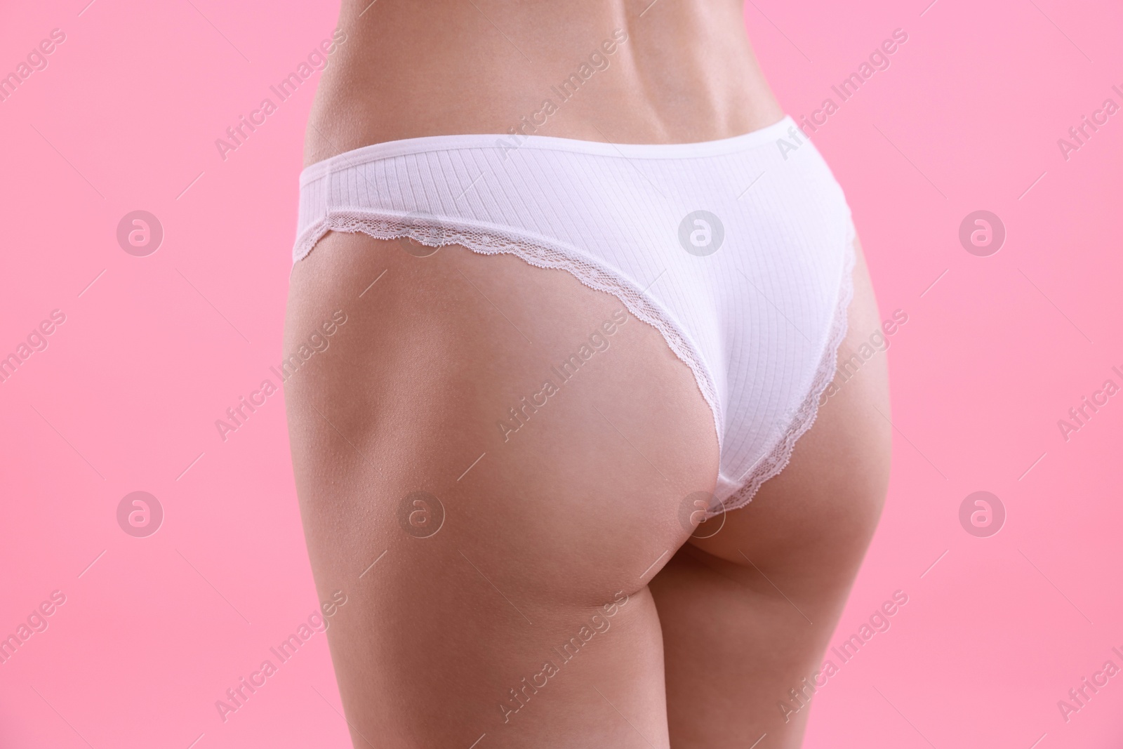 Woman wearing beautiful underwear on pink background, closeup Photo of Woman wearing beautiful underwear on pink background, closeup