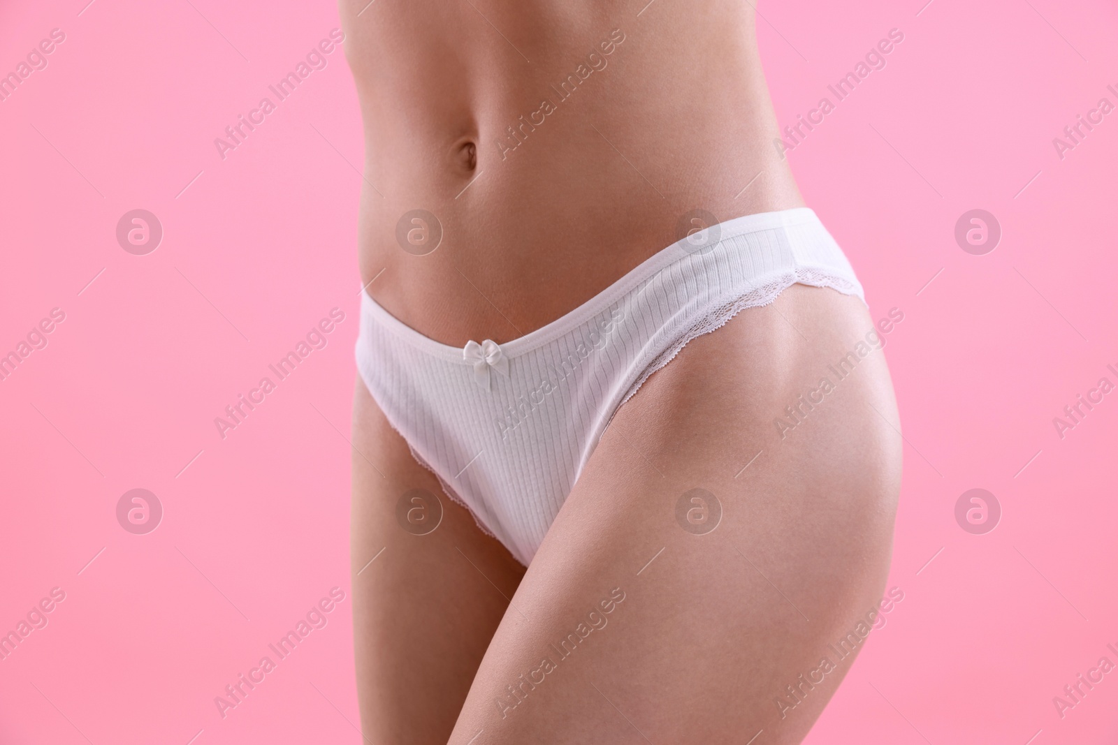 Woman wearing beautiful underwear on pink background, closeup Photo of Woman wearing beautiful underwear on pink background, closeup