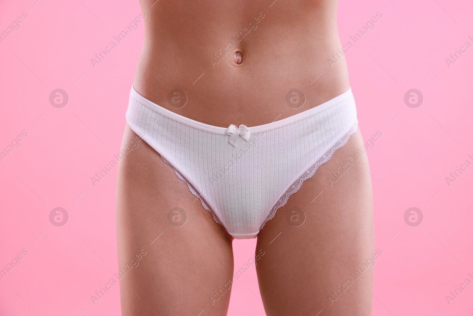Woman wearing beautiful underwear on pink background, closeup Photo of Woman wearing beautiful underwear on pink background, closeup