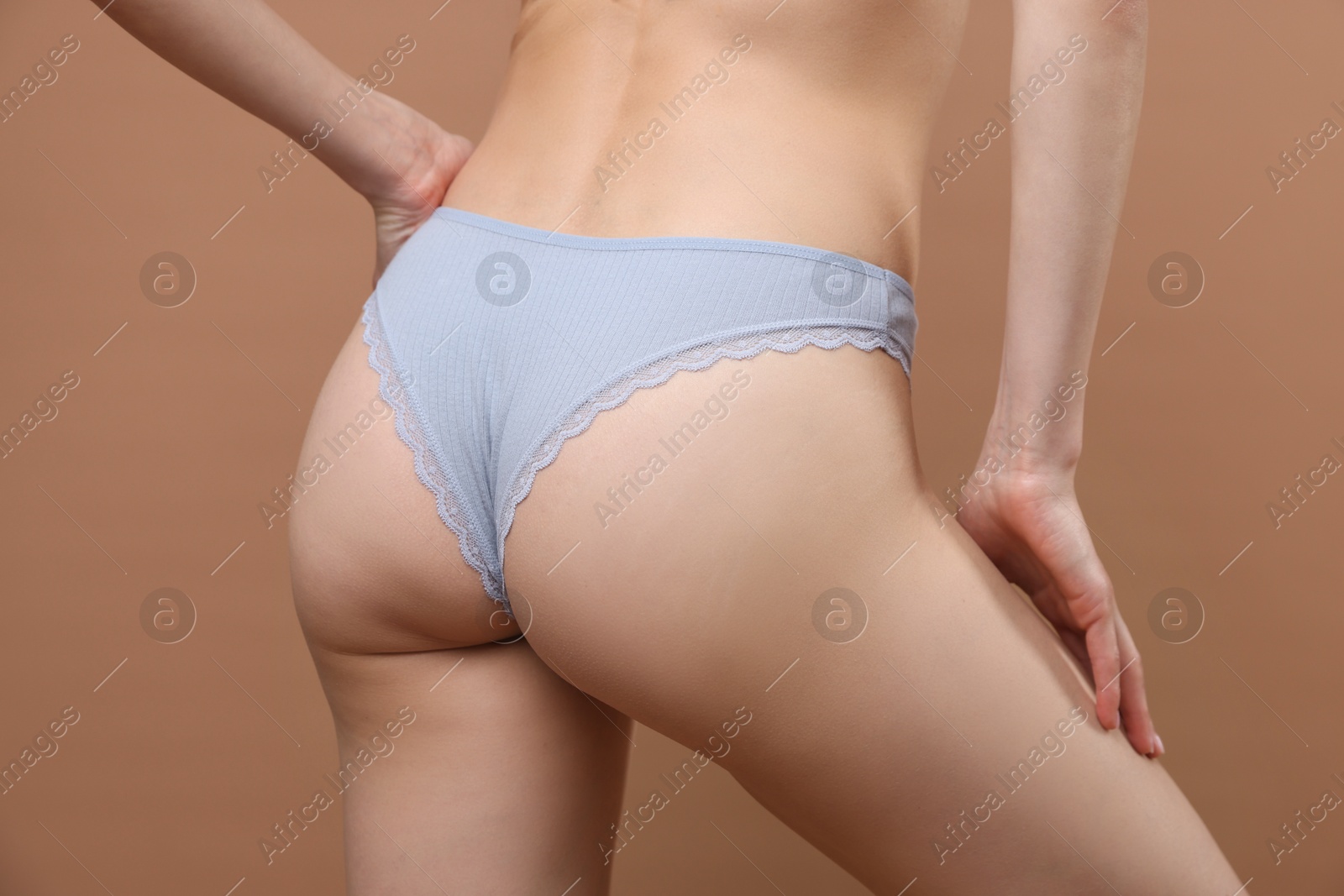 Woman wearing beautiful underwear on brown background, closeup Photo of Woman wearing beautiful underwear on brown background, closeup