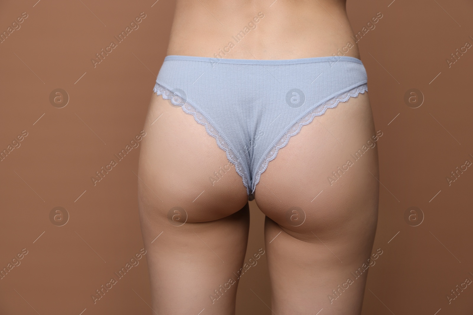 Woman wearing beautiful underwear on brown background, closeup Photo of Woman wearing beautiful underwear on brown background, closeup