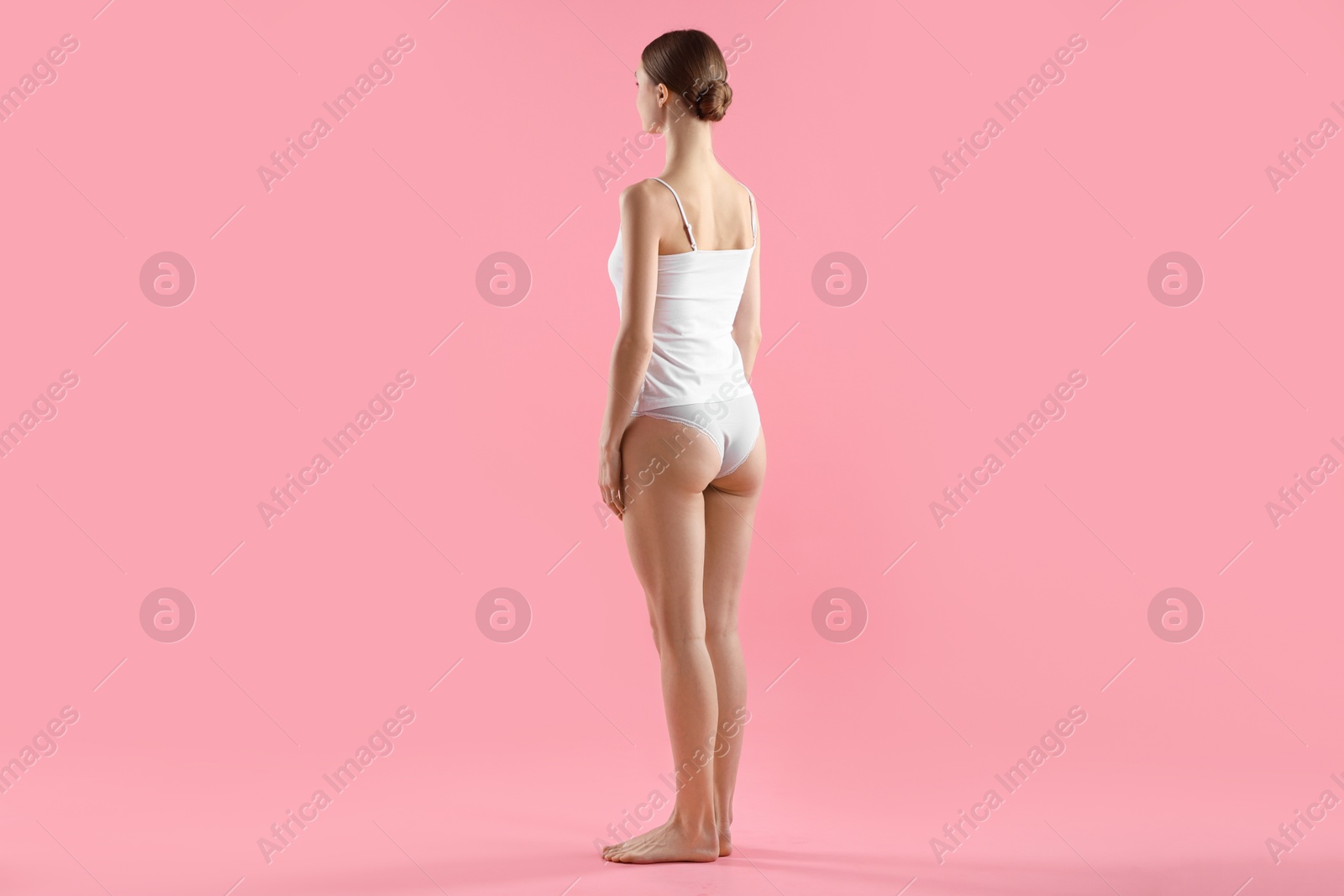 Woman wearing beautiful underwear on pink background Photo of Woman wearing beautiful underwear on pink background