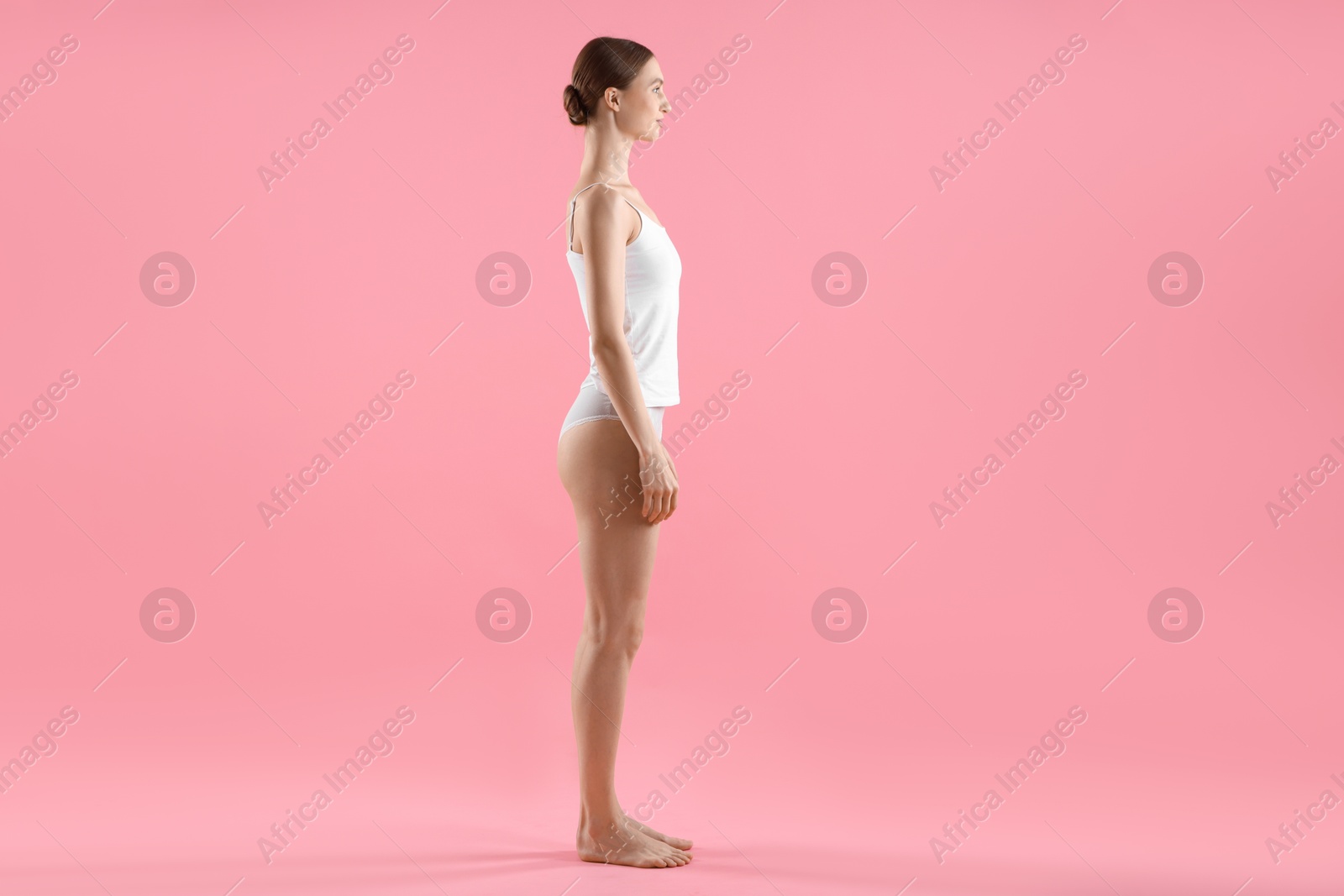 Woman wearing beautiful underwear on pink background Photo of Woman wearing beautiful underwear on pink background