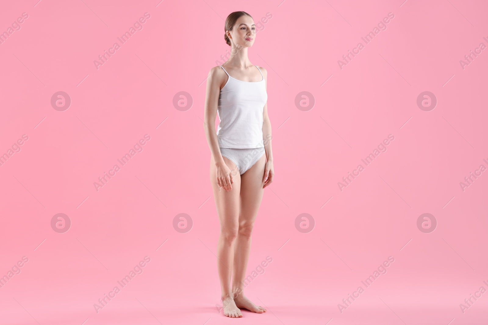 Woman wearing beautiful underwear on pink background Photo of Woman wearing beautiful underwear on pink background