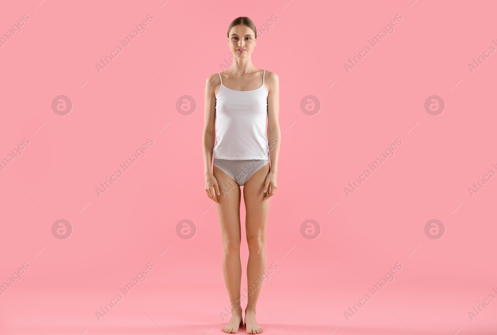 Woman wearing beautiful underwear on pink background Photo of Woman wearing beautiful underwear on pink background