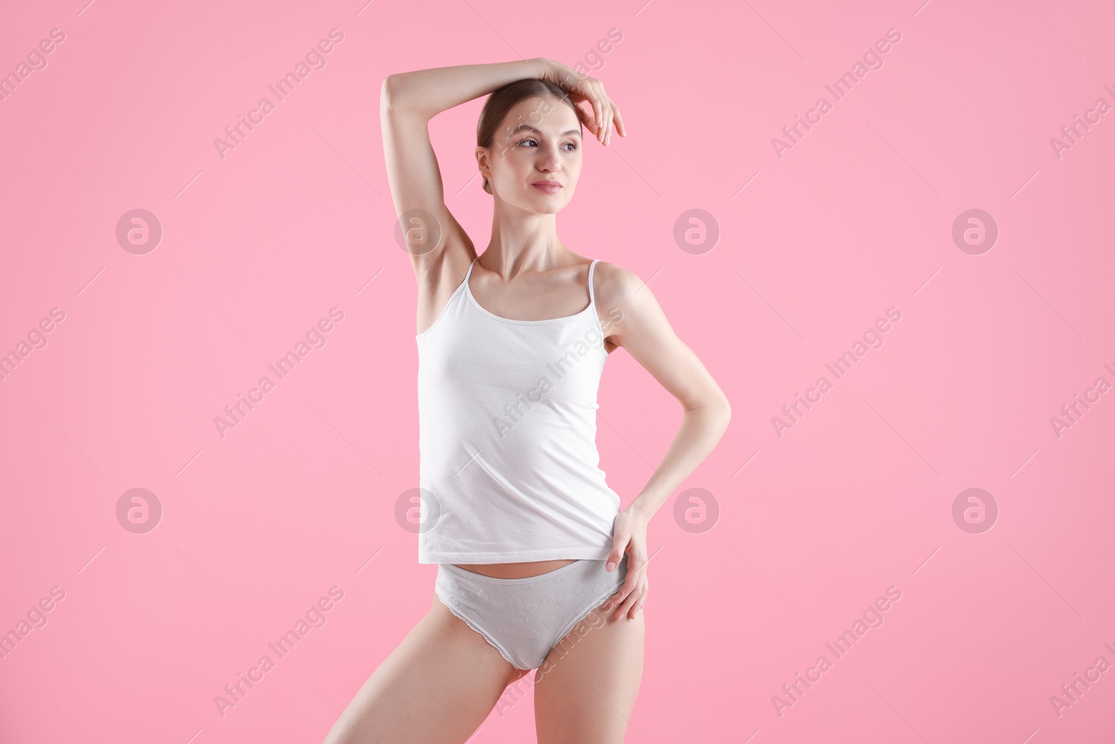 Woman wearing beautiful underwear on pink background Photo of Woman wearing beautiful underwear on pink background