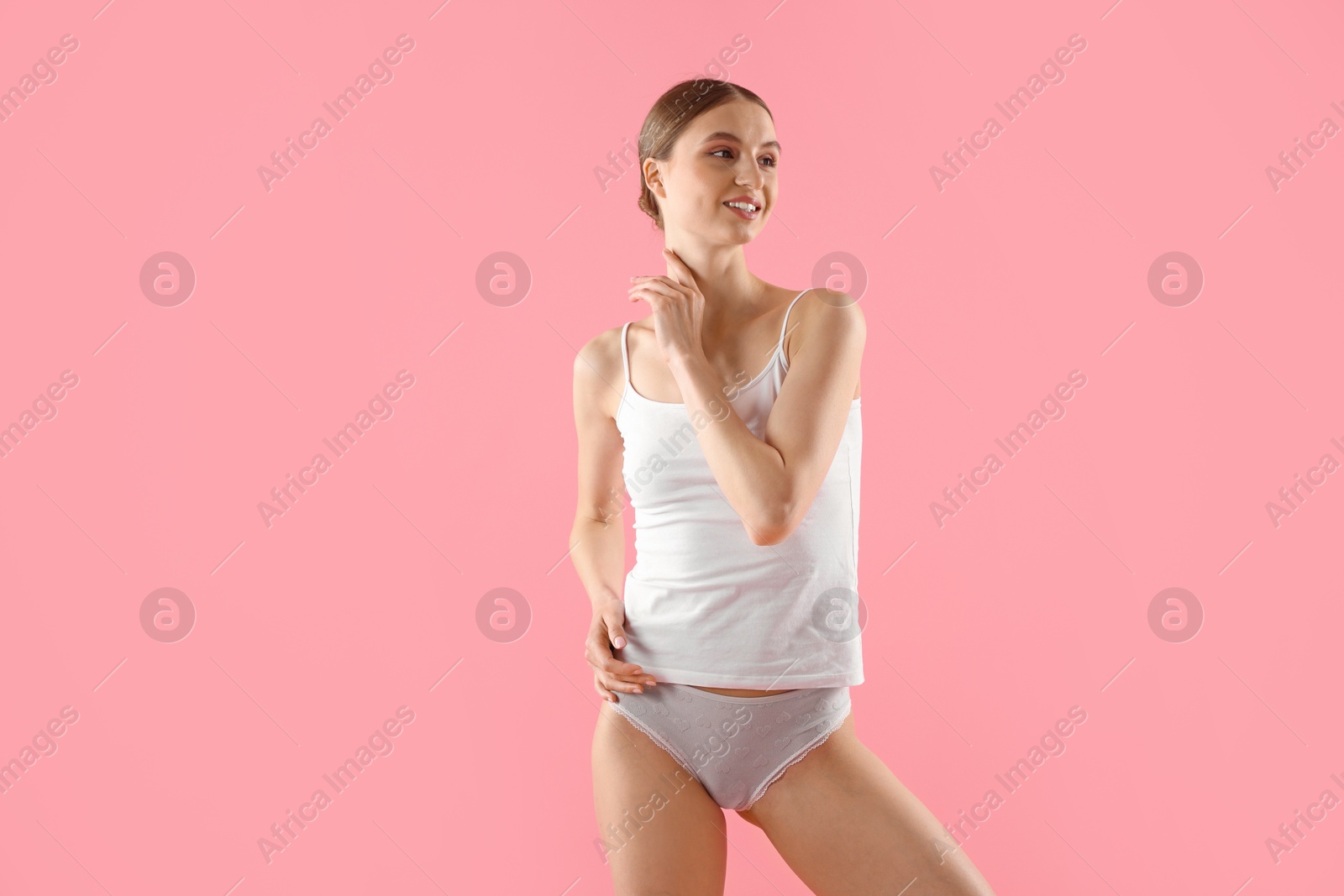 Woman wearing beautiful underwear on pink background Photo of Woman wearing beautiful underwear on pink background
