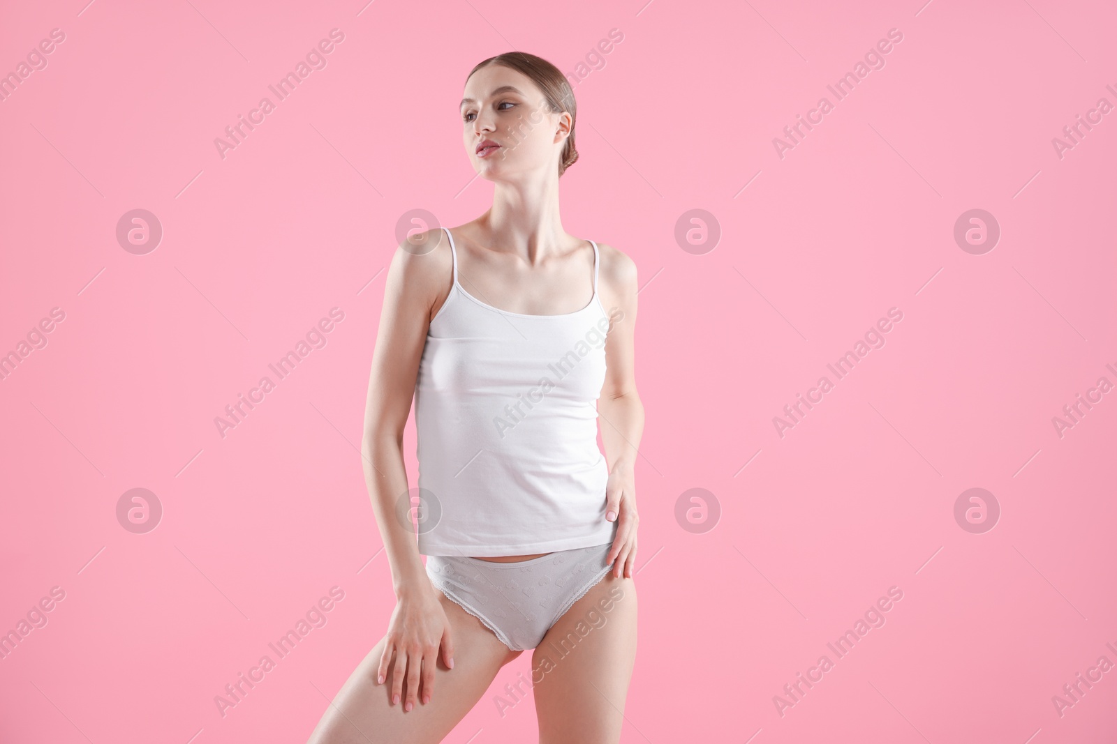 Woman wearing beautiful underwear on pink background Photo of Woman wearing beautiful underwear on pink background