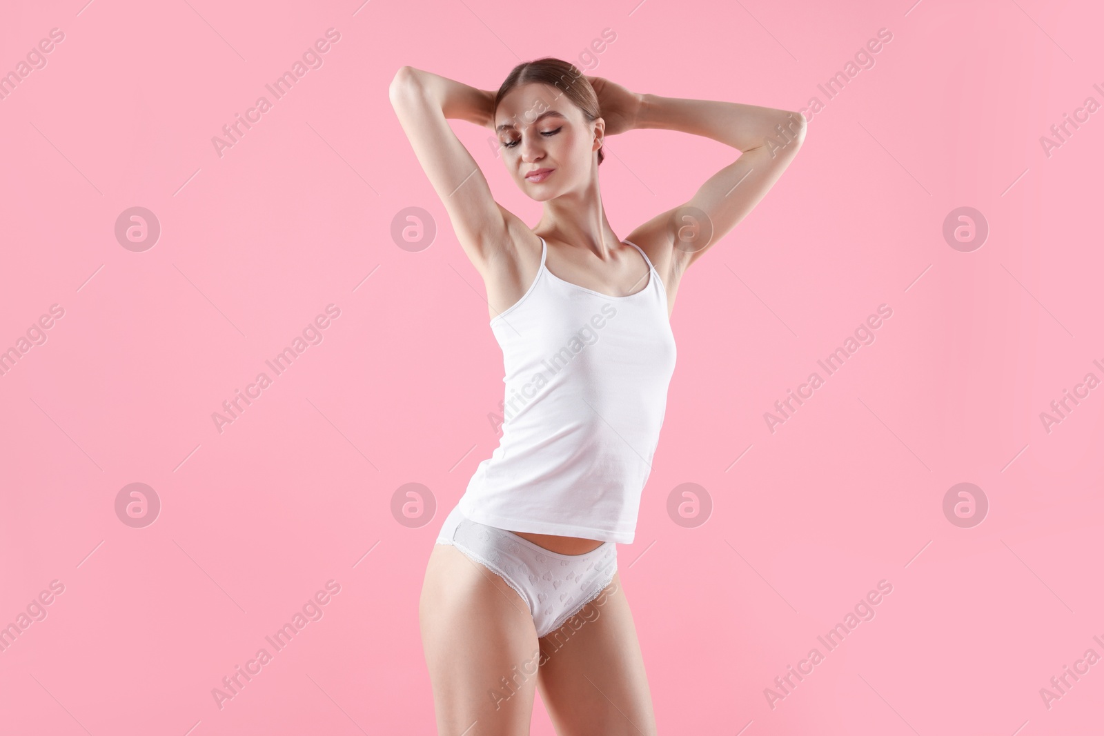 Woman wearing beautiful underwear on pink background Photo of Woman wearing beautiful underwear on pink background
