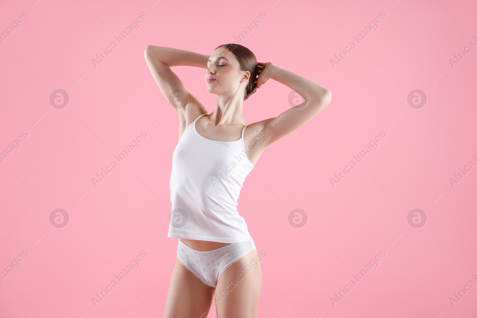 Woman wearing beautiful underwear on pink background Photo of Woman wearing beautiful underwear on pink background