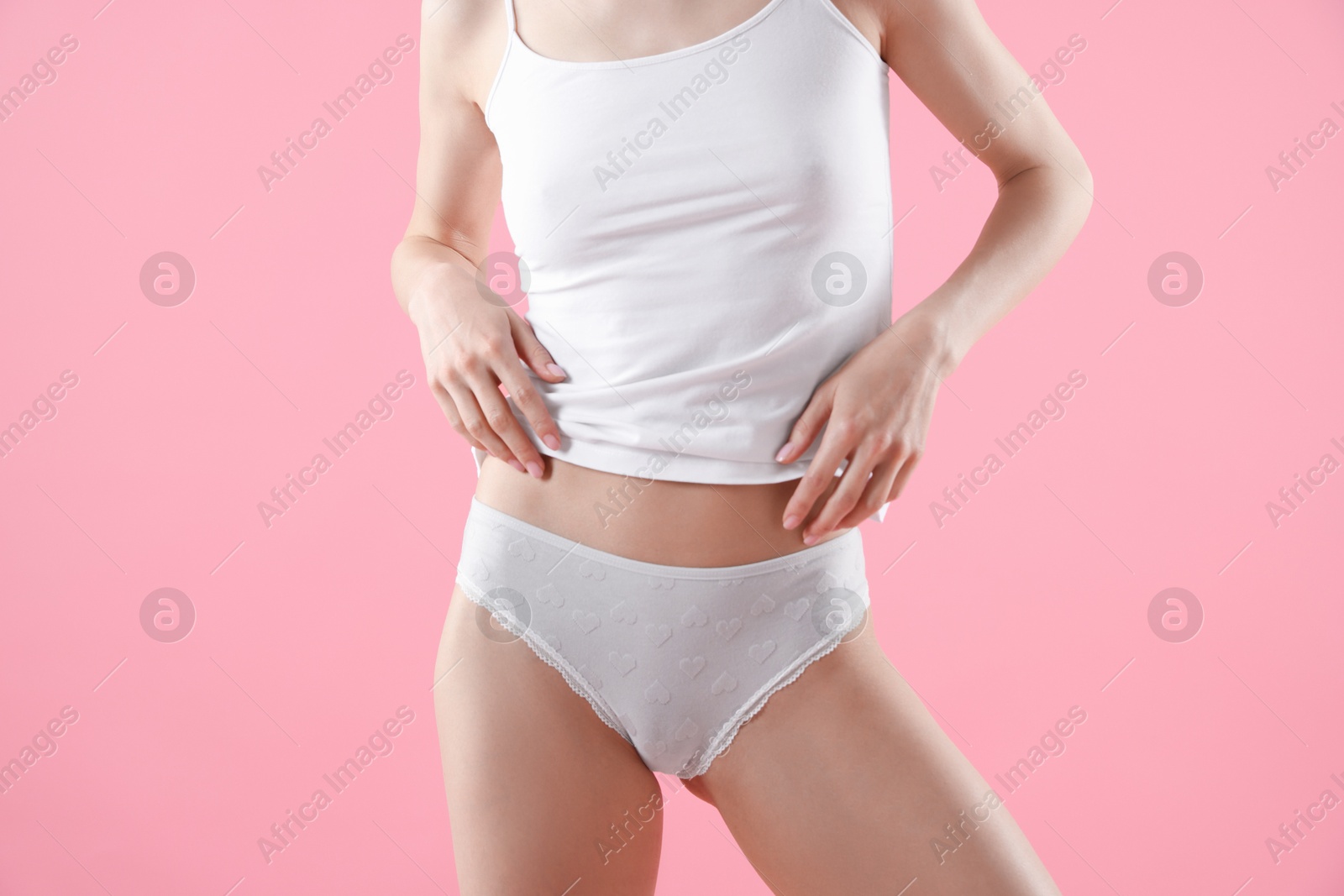 Woman wearing beautiful underwear on pink background, closeup Photo of Woman wearing beautiful underwear on pink background, closeup