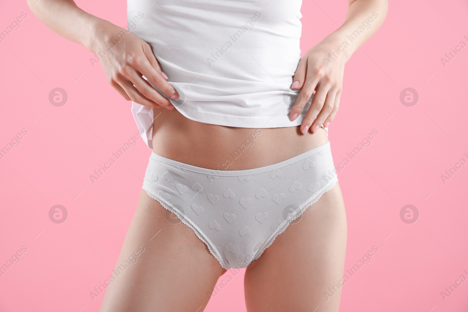 Woman wearing beautiful underwear on pink background, closeup Photo of Woman wearing beautiful underwear on pink background, closeup