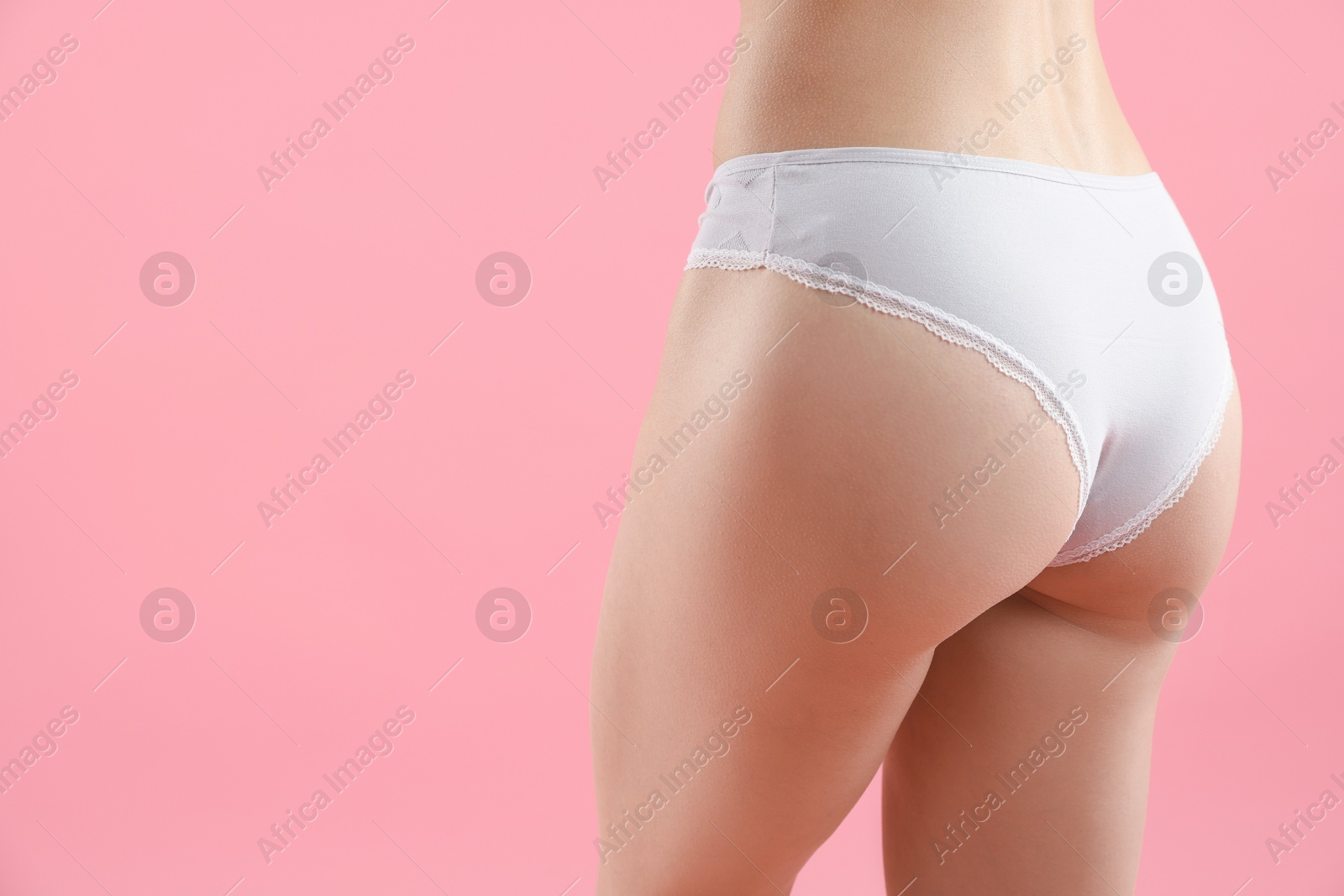Woman wearing beautiful underwear on pink background, closeup. Space for text Photo of Woman wearing beautiful underwear on pink background, closeup. Space for text