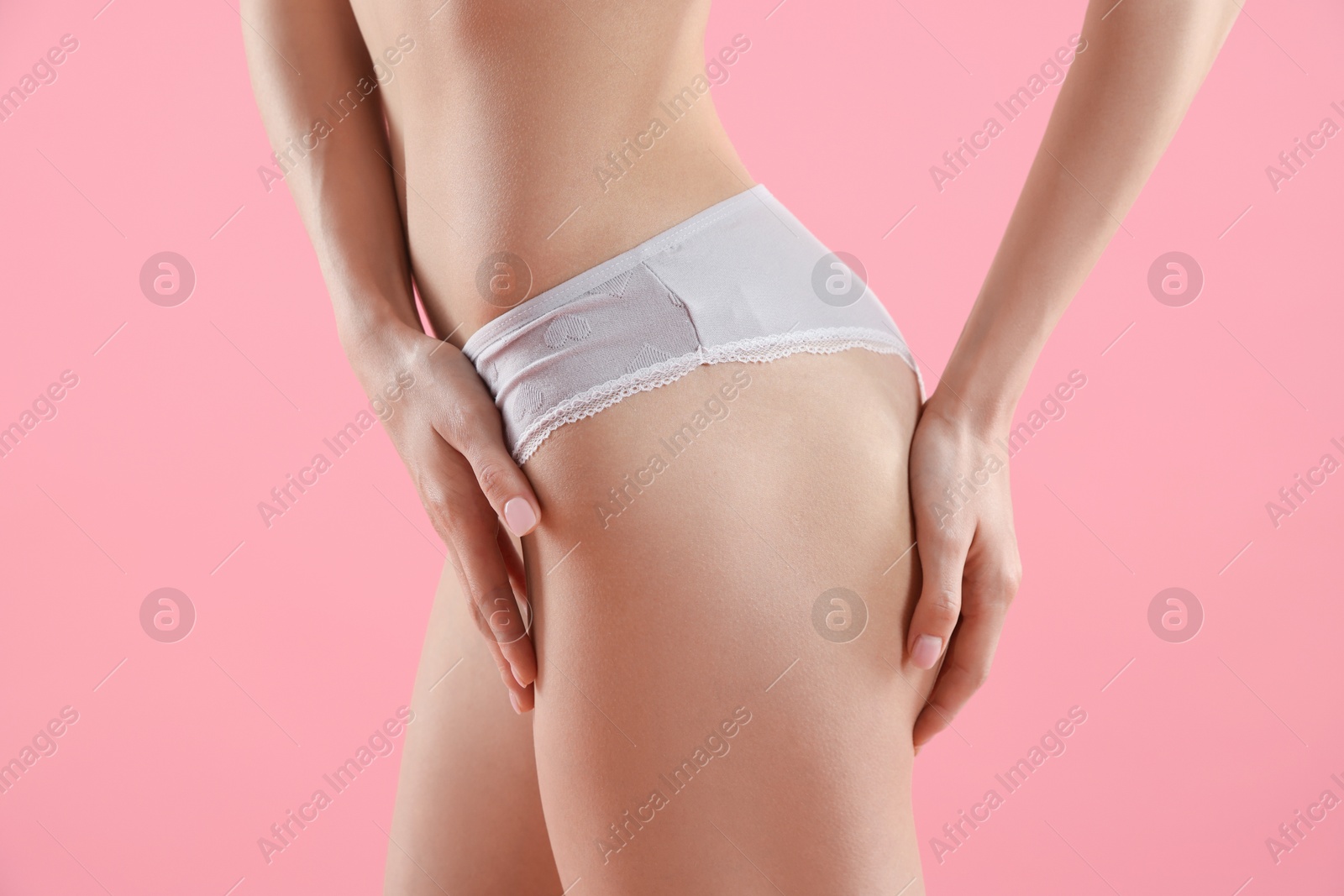 Woman wearing beautiful underwear on pink background, closeup Photo of Woman wearing beautiful underwear on pink background, closeup