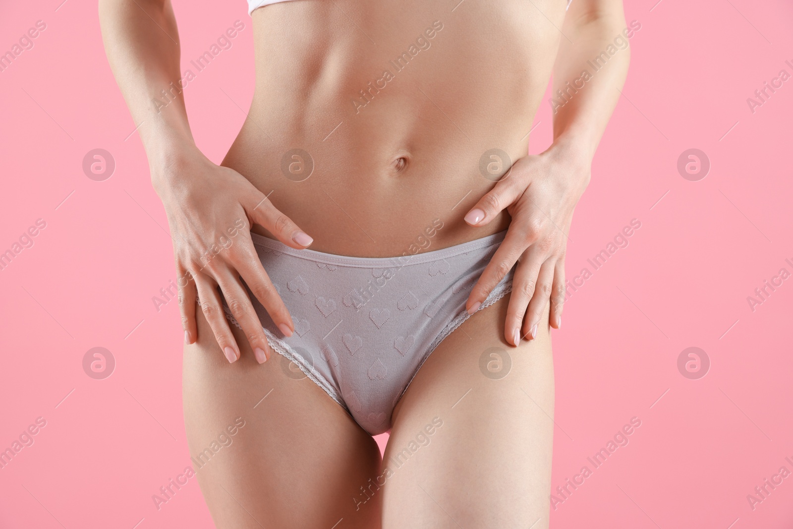 Woman wearing beautiful underwear on pink background, closeup Photo of Woman wearing beautiful underwear on pink background, closeup