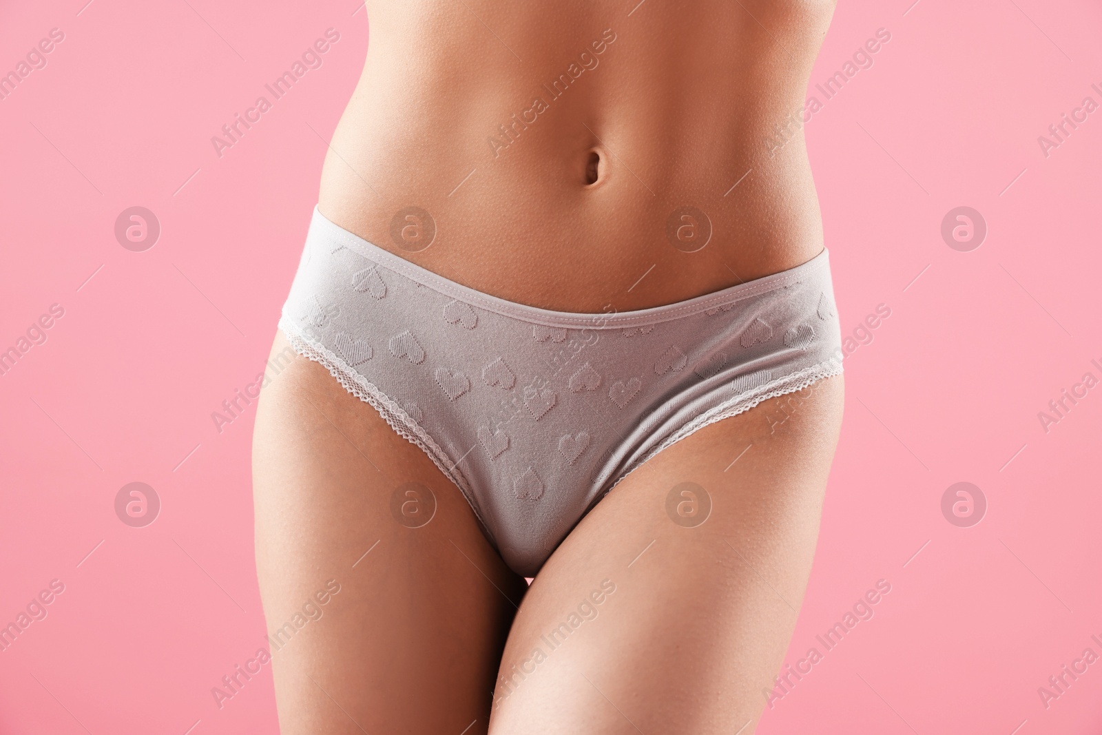 Woman wearing beautiful underwear on pink background, closeup Photo of Woman wearing beautiful underwear on pink background, closeup