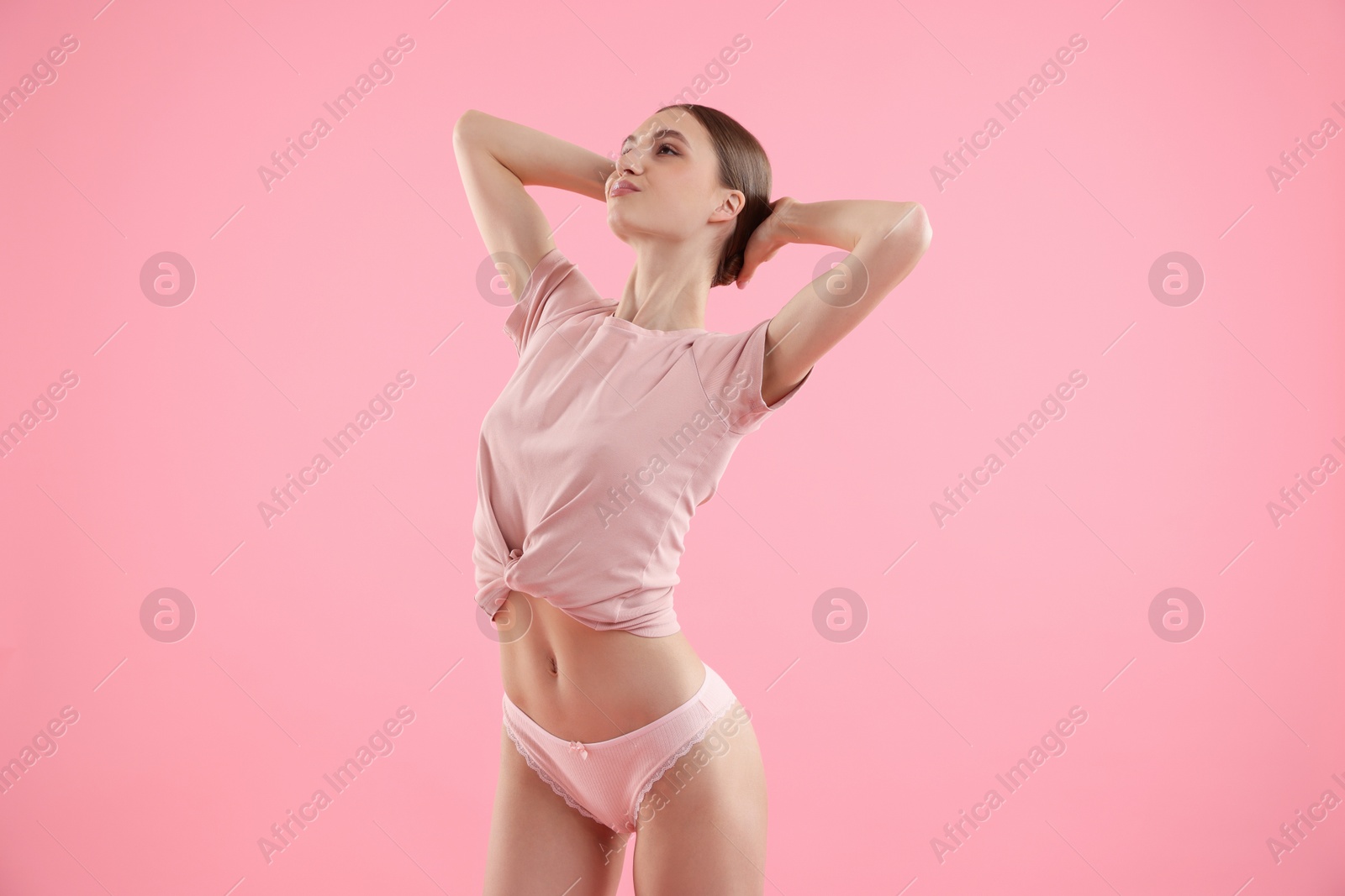 Woman wearing beautiful underwear on pink background Photo of Woman wearing beautiful underwear on pink background