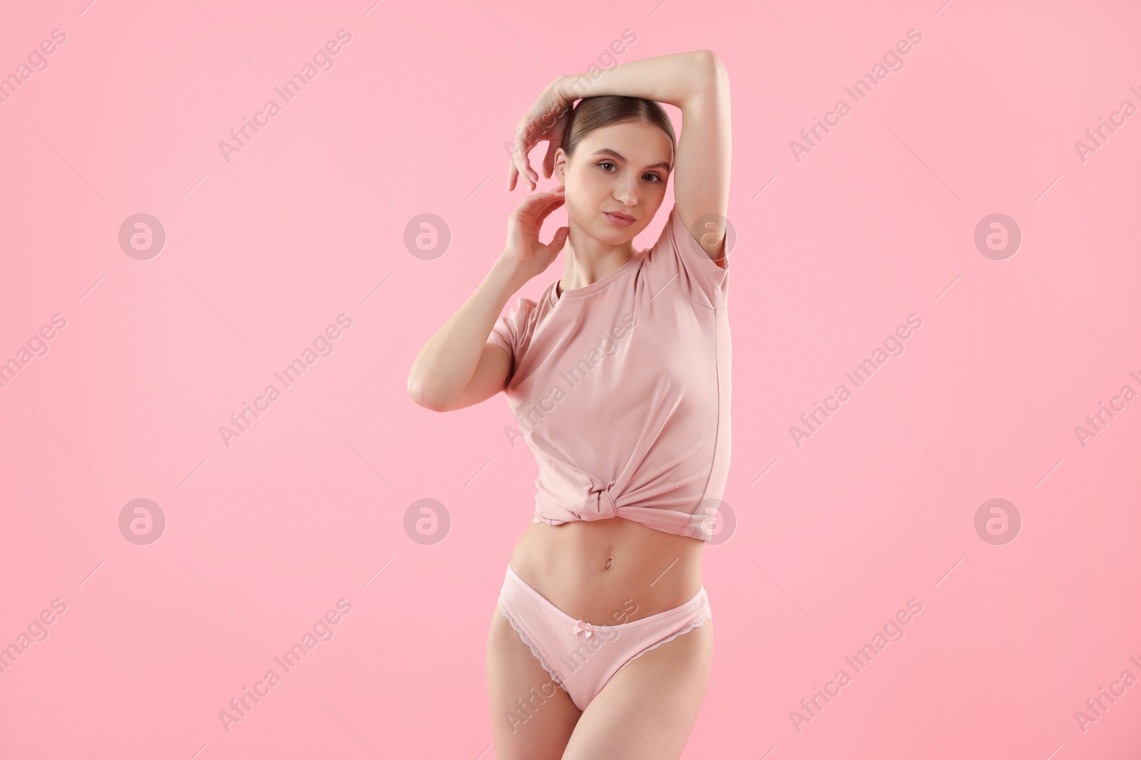 Woman wearing beautiful underwear on pink background Photo of Woman wearing beautiful underwear on pink background