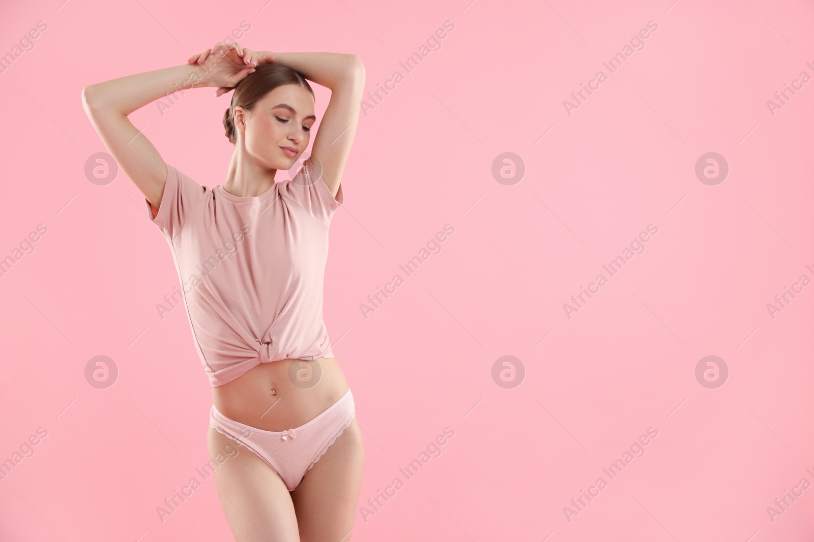 Woman wearing beautiful underwear on pink background, space for text Photo of Woman wearing beautiful underwear on pink background, space for text