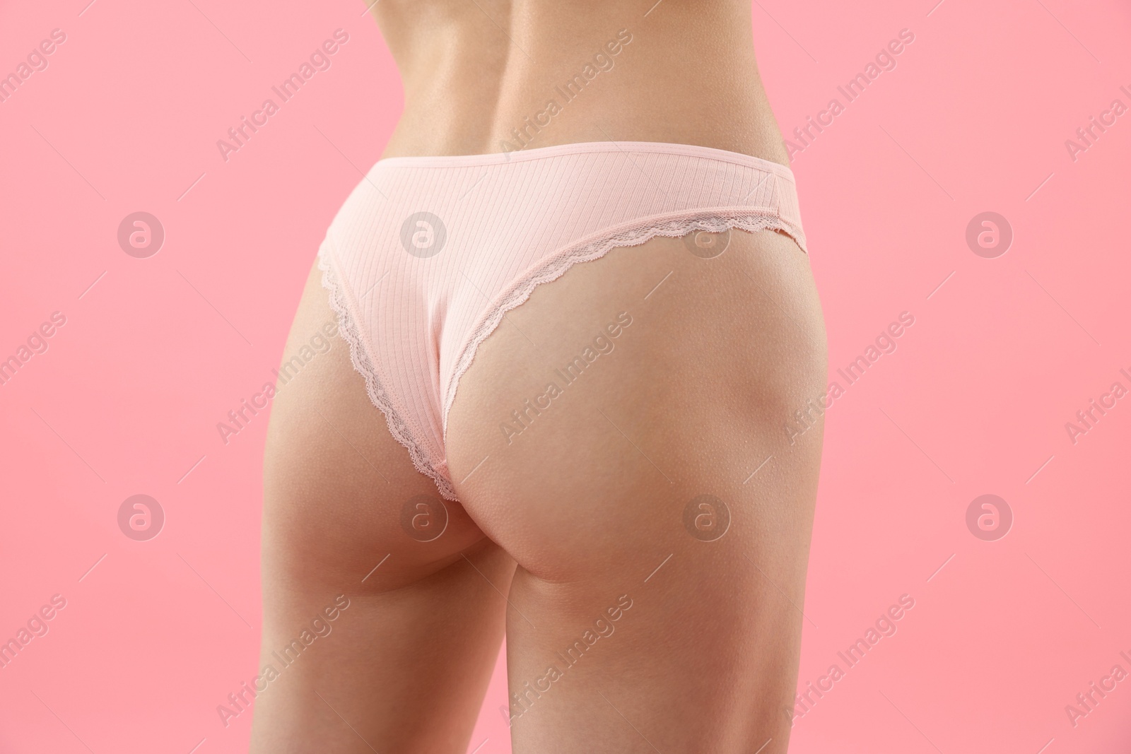 Woman wearing beautiful underwear on pink background, closeup Photo of Woman wearing beautiful underwear on pink background, closeup