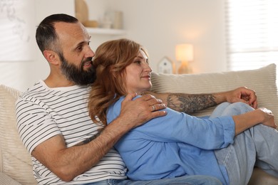 Photo of Portrait of lovely couple on sofa at home