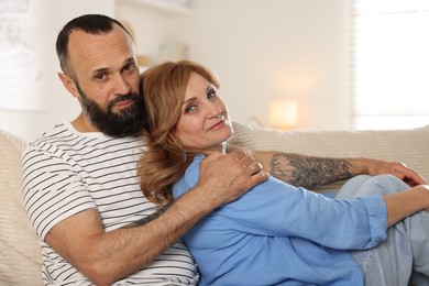 Photo of Portrait of lovely couple on sofa at home