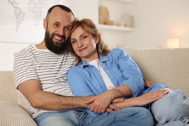 Photo of Portrait of lovely couple on sofa at home