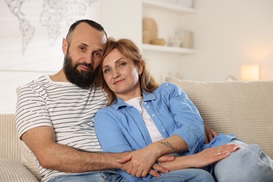 Photo of Portrait of lovely couple on sofa at home