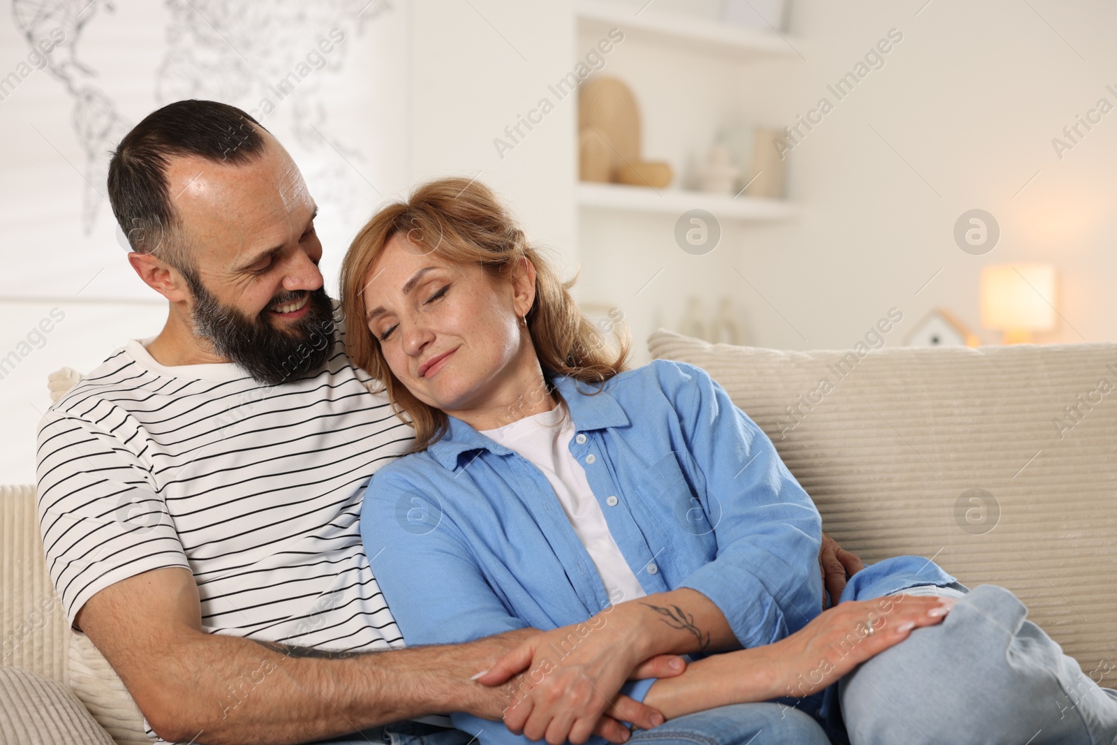 Photo of Portrait of lovely couple on sofa at home