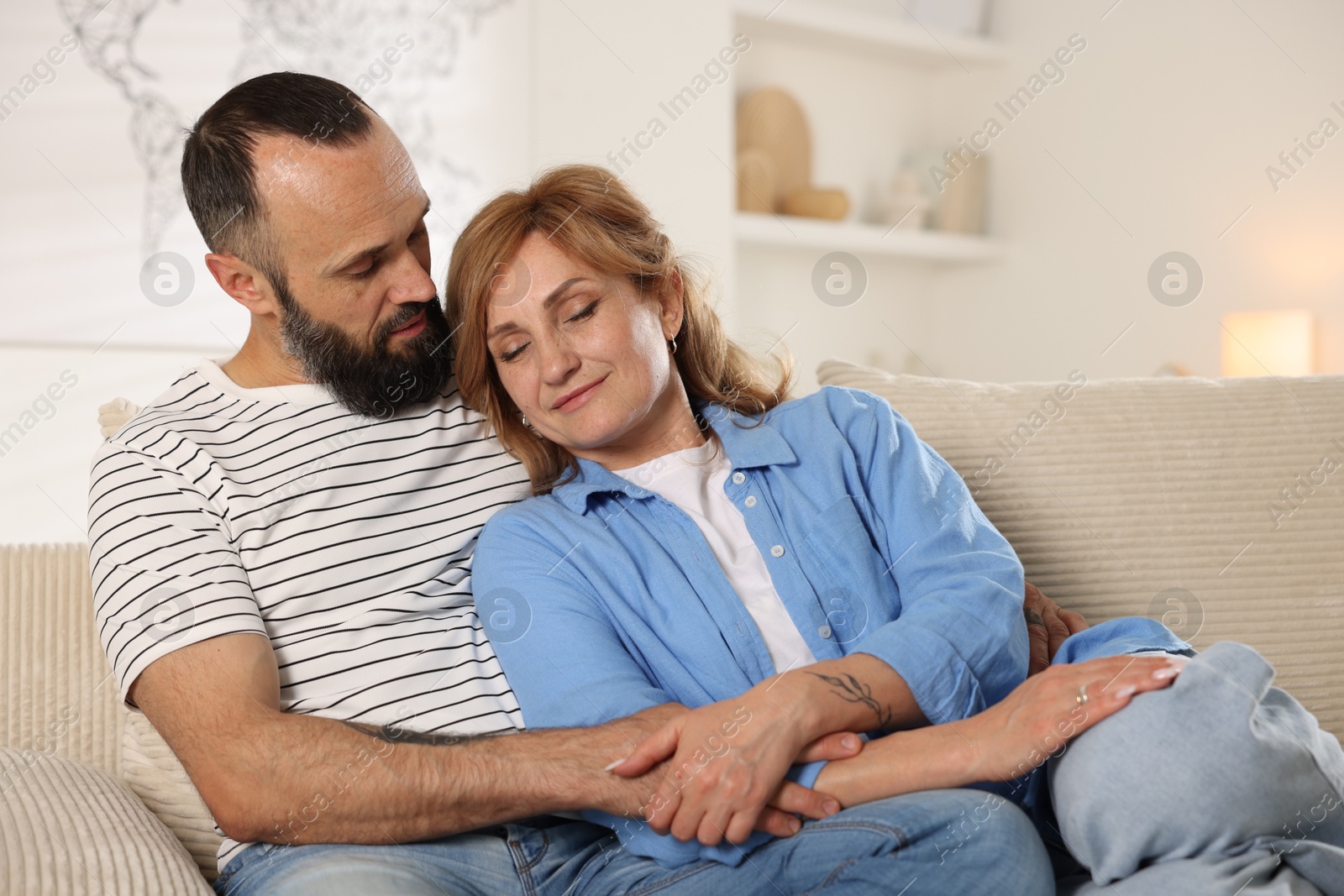 Portrait of lovely couple on sofa at home Photo of Portrait of lovely couple on sofa at home