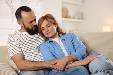 Photo of Portrait of lovely couple on sofa at home