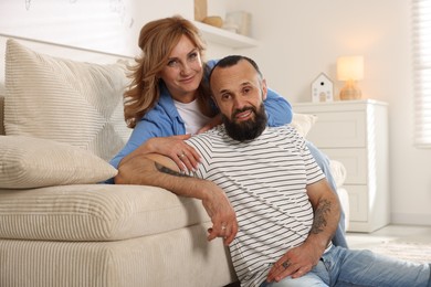Photo of Portrait of happy mature couple at home