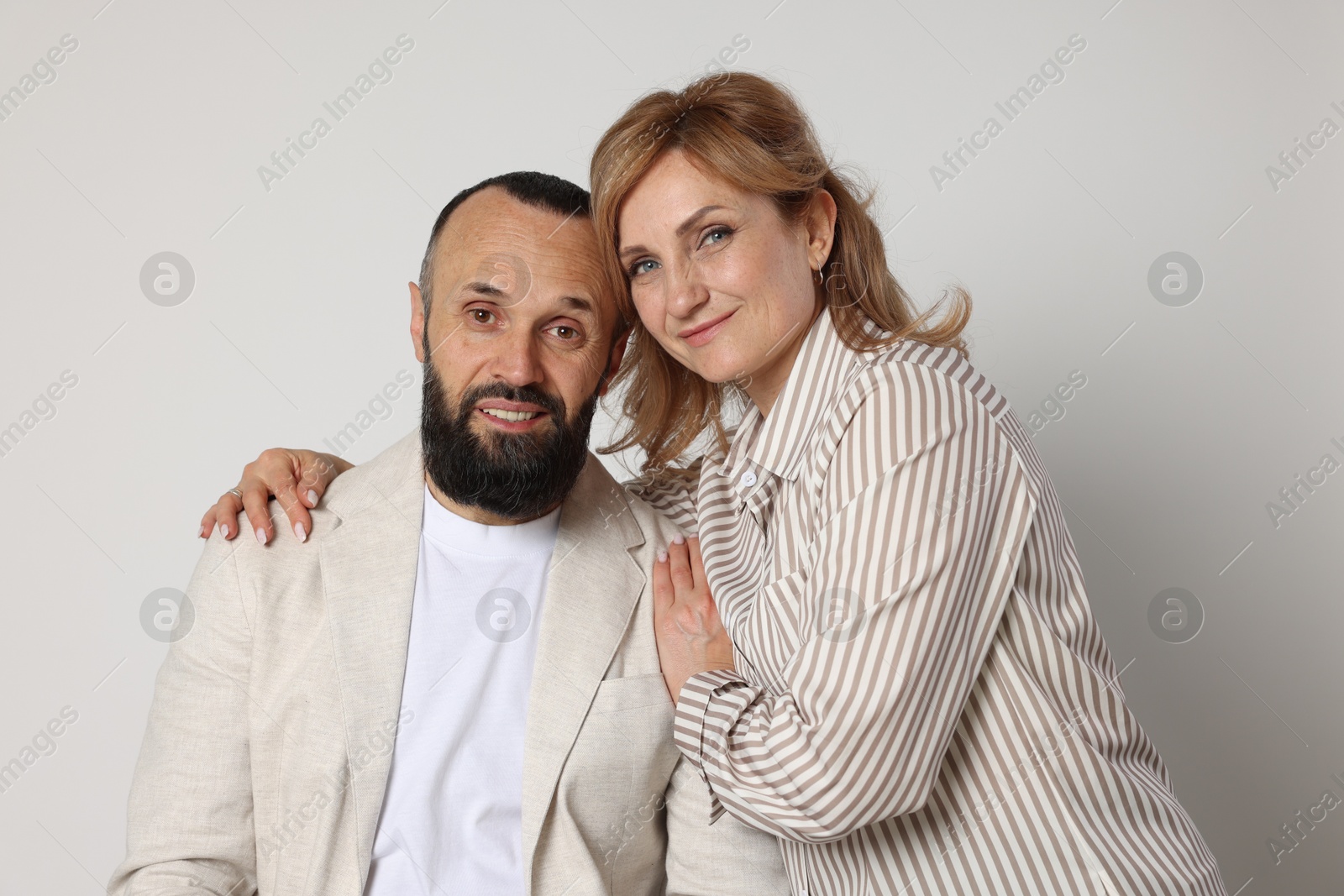 Portrait of lovely couple on light grey background Photo of Portrait of lovely couple on light grey background