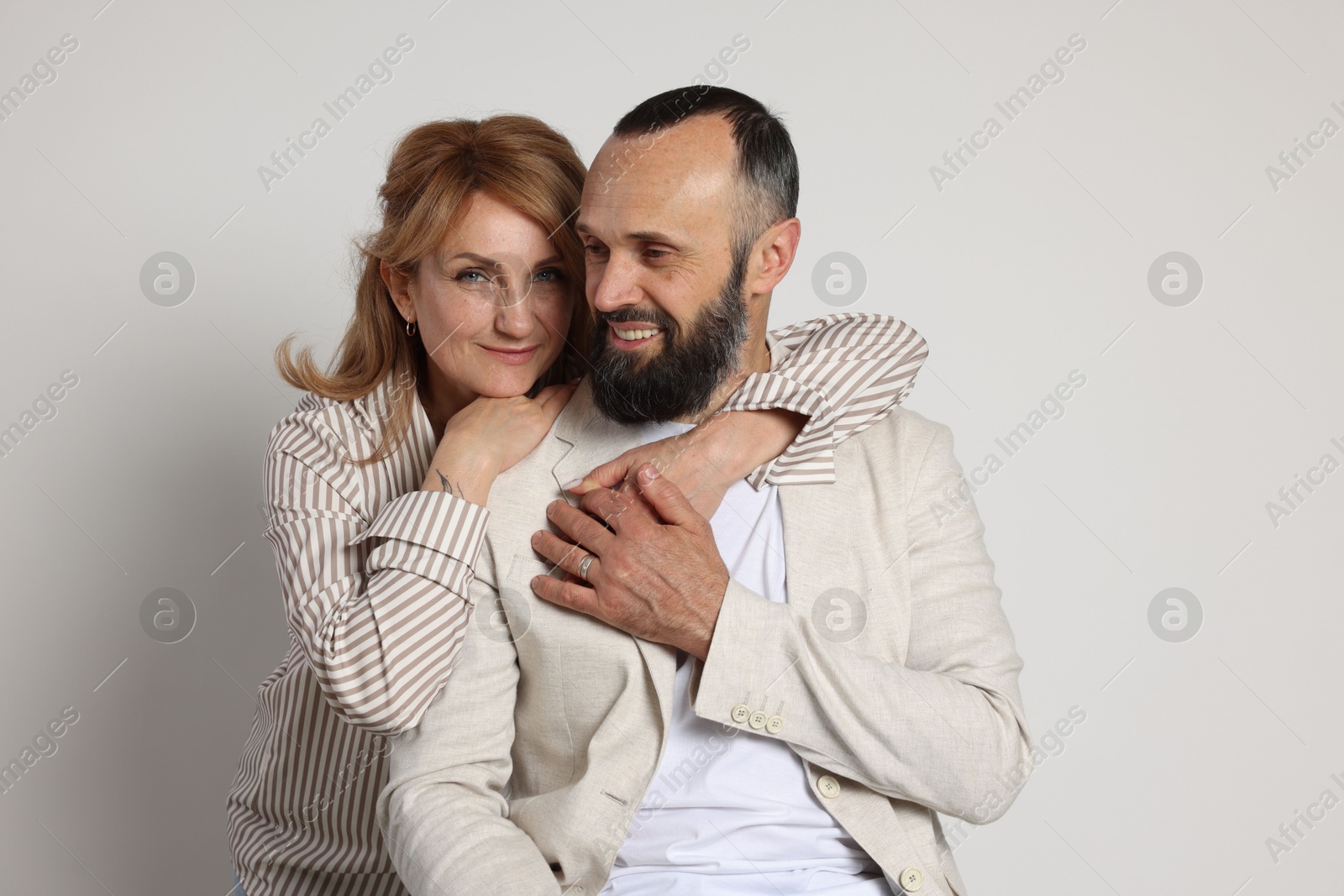 Portrait of lovely couple on light grey background Photo of Portrait of lovely couple on light grey background
