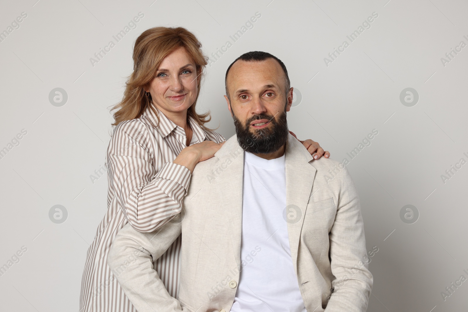 Portrait of lovely couple on light grey background Photo of Portrait of lovely couple on light grey background