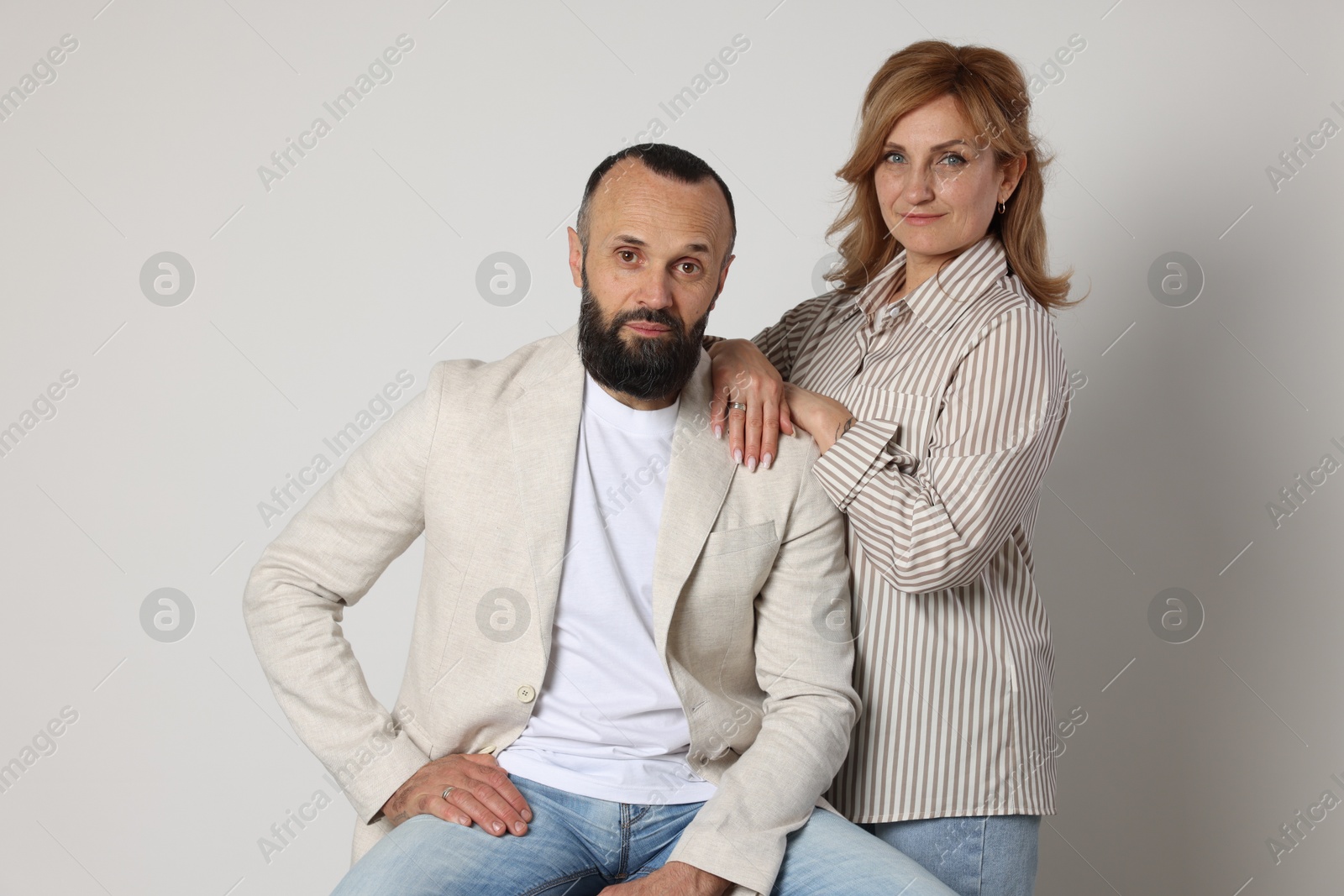Portrait of lovely couple on light grey background Photo of Portrait of lovely couple on light grey background